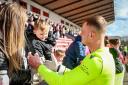 Cup-winning goalkeeper Kelby Mason celebrates with the fans, including son Kelby, after Tranent lifted the Lowland League Cup. Image: Alan Wilson