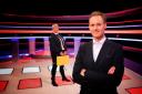Debs Anderson stands behind presenter Dan Walker on the set of new BBC One gameshow Chase the Case