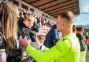 Cup-winning goalkeeper Kelby Mason celebrates with the fans, including son Kelby, after Tranent lifted the Lowland League Cup. Image: Alan Wilson