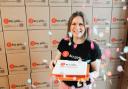 Hannah Cooke, national free period product provision and donations co-ordinator, with the cake as Hey Girls, which aims to eradicate period poverty, celebrates after donating 30 million products to vulnerable people as it marks is fifth birthday