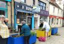 Volunteers get busy weeding the planters in the High Street