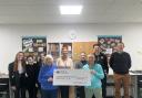 Willie Daisley, club captain at Winterfield Golf Club, and Chris McArthur, ladies’ vice-captain, hand over the cheque to Dunbar Grammar School pupils and staff