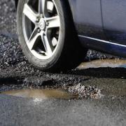 Residents are being urged to report potholes to the council