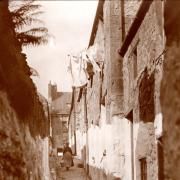The ‘Johnstone’s Close’ postcard, looking towards the High Street from the Castle Street end