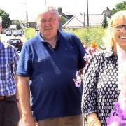 From left: Ian, Dougie, and Maureen following a presentation of tokens of appreciation with a bouquet of flowers on behalf of Macmerry and Gladsmuir Community Council