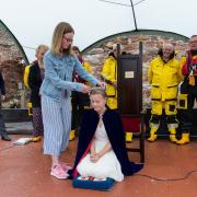 Lifeboat Queen Poppy receives her crown from twin sister Ciara. Photo: Alistair Punton