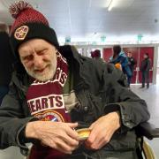 John at Tynecastle with his new hat and scarf enjoying a pie