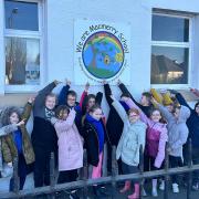 Pupils gathered outside to unveil the new school logo at Macmerry Primary School