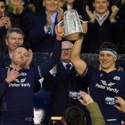 Scotland's Finn Russell (left) and Rory Darge lift the Calcutta Cup after victory in the Guinness Six Nations match at Scottish Gas Murrayfield Stadium on Saturday. Image: Andrew Milligan/PA Wire