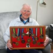 Willie pictured with his 13 world-stage gold medals including two Commonwealth Games gold medals and eight world championship golds