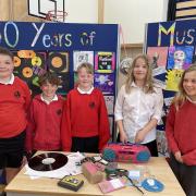 These current Law Primary School pupils explore music through the decades at Law Primary School... learning all about cassette tapes and vinyl