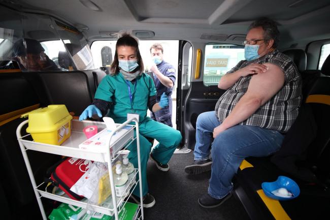 Medical student Leona Leipold after giving Bradley Winfield the Oxford/AstraZeneca Covid-19 vaccination in the back of a taxi (Yui Mok/PA)