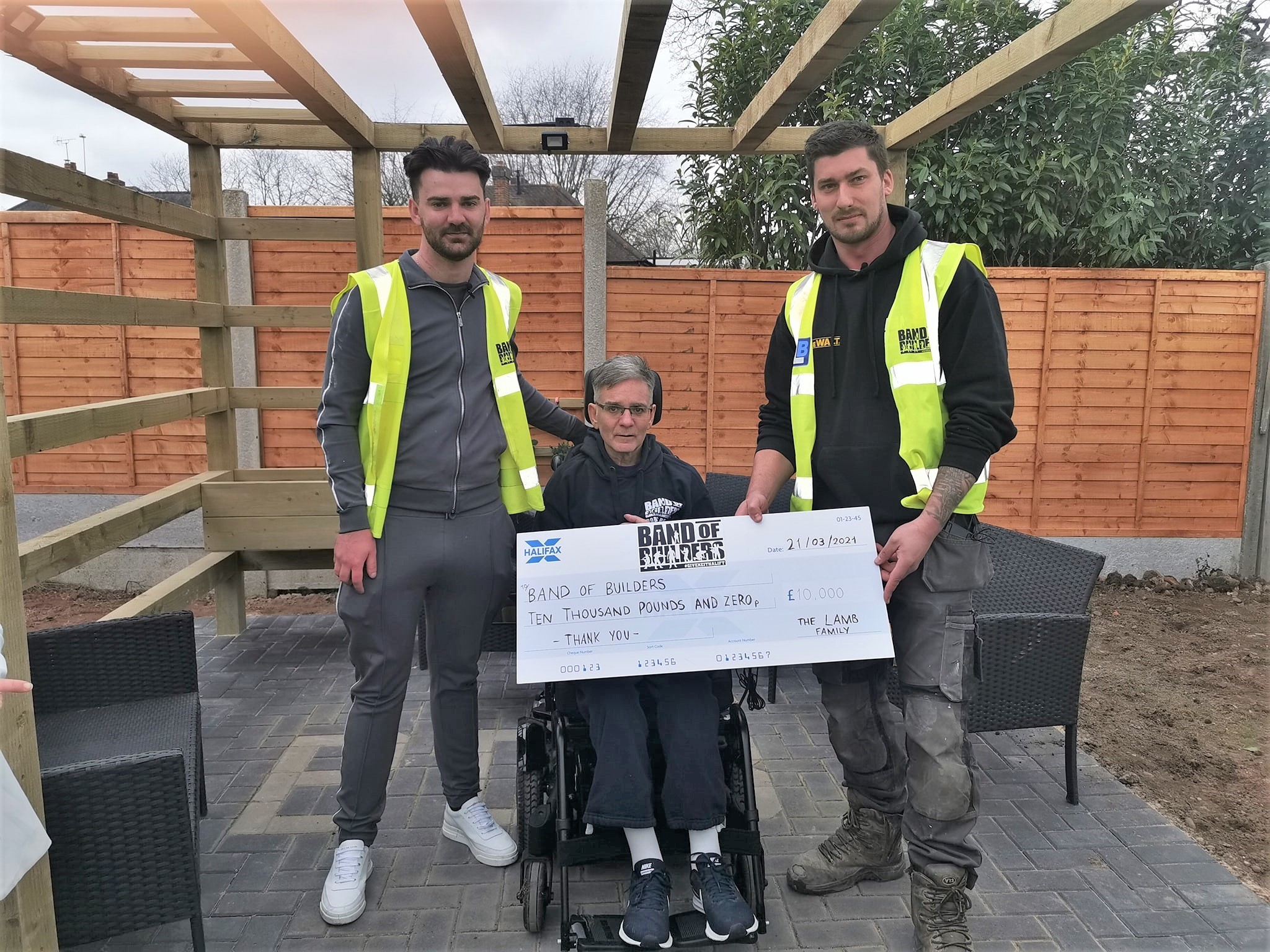 The Lamb family handed over a cheque for £10,000 to Band of Builders.