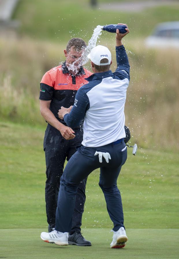 East Lothian Courier: Fellow Scottish golfer Calum Hill congratulated Grant Forrest in a memorable first European Tour success. Picture: Ian Rutherford/PA Wire