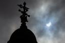 Partial solar eclipse seen over the City Chambers in George Square in Glasgow. Photograph by Colin Mearns, 10 June 2021