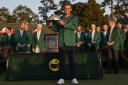 Scottie Scheffler holds the championship trophy after winning the 86th Masters golf tournament on Sunday, April 10, 2022, in Augusta, Ga. (AP Photo/David J. Phillip).