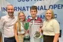 Logan Kennedy (second from right), pictured with dad Scott Kennedy, sister Lucy Hogg and mum Kelly Kennedy, was celebrating making history on the green