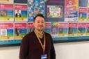 David Russell-Fitzgerald, principal teacher of guidance at Ross High School, next to the school’s display for LGBT History Month