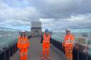 A railway station is due to open in East Linton within the next 12 months. Pictured, from left: Lisa McKenna (Network Rail), Craig Hoy MSP and Phil Pree (BAM Nuttall) on the bridge of the new station