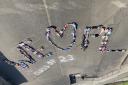 Pupils came together to create a 'we love PL' sign outside