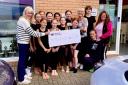Carol Edmond, left, and Barbara Edgar, right, both from the Over 50's Club, present a cheque for £1,000 to the Louise Collie Dance Company to help with transport costs to a dance convention in Liverpool in October