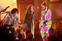 Aerosmith’s Steve Tyler, centre, performs with Post Malone, right, and Joe Perry (PA)