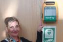 Diane Gray from ELHSCP Primary Care Team points out the AED located within Musselburgh Primary Care Centre