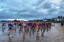 A total of 130 children and adults braved the conditions to take part in the North Berwick Santa Beach Run