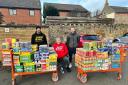 Johnnie Meechan (centre) and his family made a sizeable donation to East Lothian Foodbank