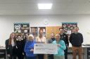 Willie Daisley, club captain at Winterfield Golf Club, and Chris McArthur, ladies’ vice-captain, hand over the cheque to Dunbar Grammar School pupils and staff