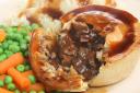 Steak pie with mashed potato, peas, carrots and gravy..