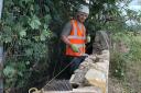 Apprentice stonemason Darren Brown at work on the boundary wall at the new learning campus at Wallyford