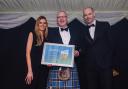 Alan Thomson, manager of Fenton Tower (centre), is congratulated by Eilidh Bennett, head of property relations for The Storied Collection, and Bryce Ritchie, editor of Bunkered magazine