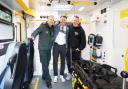 Callum Beattie, centre, views the interior of an ambulance with his manager Dave Rogers, right, and Bryan Finlay, community resilience team leader, left, during a visit to the Scottish Ambulance Service's East Ambulance Control Centre