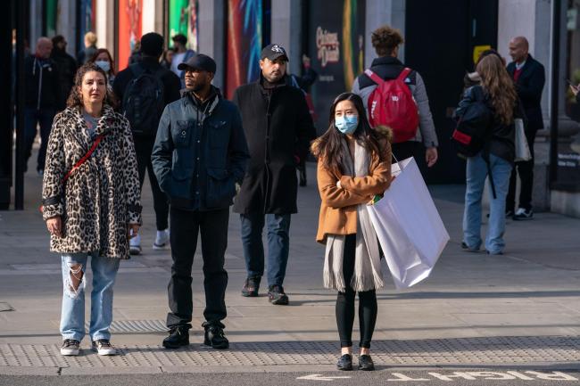 Shoppers wearing face masks on Oxford Street in central London (Dominic Lipinski/PA)