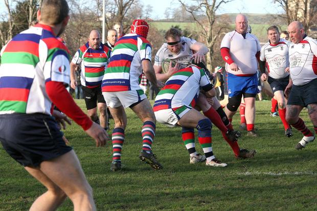 East Lothian Courier: Thousands of pounds were raised for charity as East Lothian and Haddington Barbarians Vets (white) welcomed Wooden Spoon Vets to Neilson Park