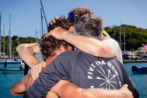 East Lothian Courier: A group hug for the Five In A Row team as they arrive at the finish line in Antigua after their epic 3,000 mile challenge. Image: Atlantic Campaigns.