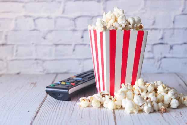 East Lothian Courier: A box of popcorn and a TV remote (Canva)