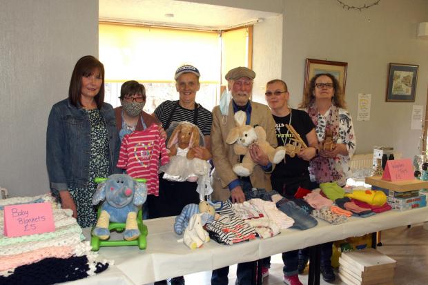 Actor James Martin, pictured centre, who played the character Eric in the hit comedy series Still Game, joins other supporters at a jumble sale in aid of the Hollies Community Hub. Pictured far right is the Hollies manager Liz Shannon.
