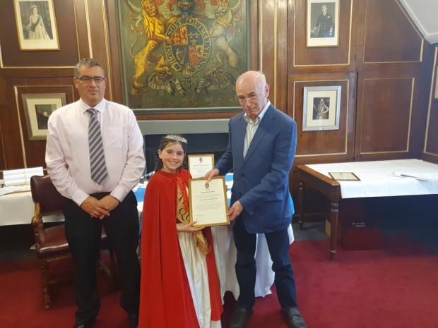 East Lothian Courier: Sandy Mitchell (right) is congratulated on his Citizen Award by Graham Adams, vice-chairman of Dunbar Community Council, and Dunbar Civic Week Queen Bella Firstbrook. Picture: Kevin Searle