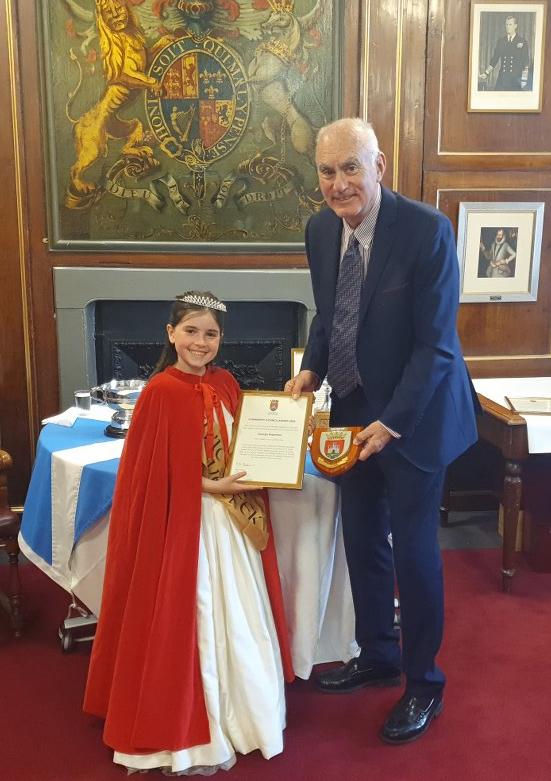 East Lothian Courier: Dunbar Civic Week Queen Bella Firstbrook hands over the Community Council Award to George Robertson. Picture: Kevin Searle