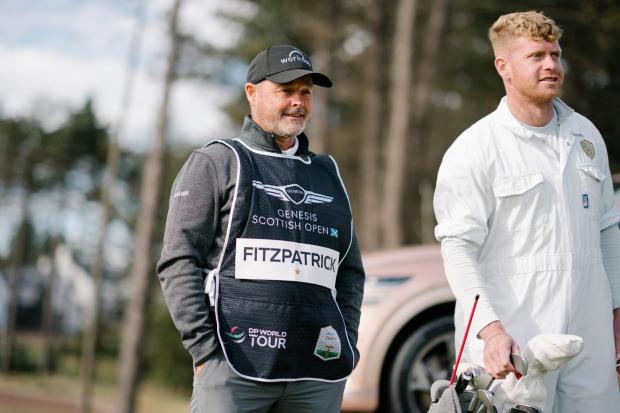 East Lothian Courier: A Genesis Electrified GV70 and a Genesis GV60 are up for grabs with a hole in one at the 17th hole during The Renaissance Club. Pictured are caddies Billy Foster and Lewis Bain. Picture: Majdanik Photography