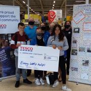 Pictured at the cheque presentation are, back row, Clark Concert Party committee members David Gibson, Lisa McKenzie, Becca Williams and Irene Grant, and Musselburgh Tesco Extra community champion Jane Shepherd, and, front row, concert party member Kai
