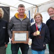Stuart Bithell (second from left) met with East Lothian Yacht Club cadets and the club's commodore. Joining him are, from left: Roo Purves, Alastair Mackinnon (with gold medal) and Nick Roche (commodore of East Lothian Yacht Club). Picture: John