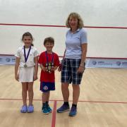 Rory Westgarth (centre) was celebrating success on the squash court