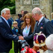Adrian McDowell, from Musselburgh, chair of Cycling Without Age, Scotland, meets King Charles III during a visit to Kinneil House. Photo: Scott Louden