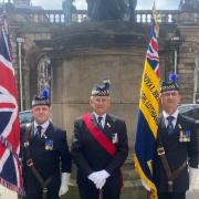 From left, Paul Cooper with the King's colour standard, Tony Hooman, national parade marshall, and William Morrison, carrying the area Legion standard at the Armed Forces flag-raising ceremony at Edinburgh City Chambers this year