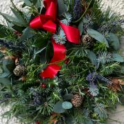Christmas wreath with different conifer foliage, eucalyptus, rosemary, dried leaves and cones