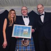 Alan Thomson, manager of Fenton Tower (centre), is congratulated by Eilidh Bennett, head of property relations for The Storied Collection, and Bryce Ritchie, editor of Bunkered magazine