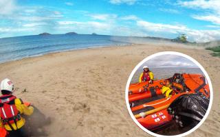 North Berwick RNLI shelter casualty as the Scottish Charity Air Ambulance lands on beach. Image: RNLI